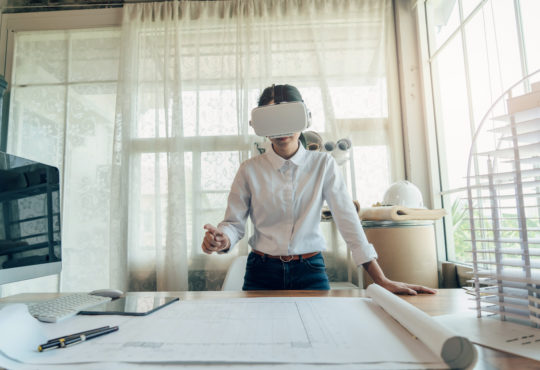 Young female working in the Metaverse with a virtual reality headset.
