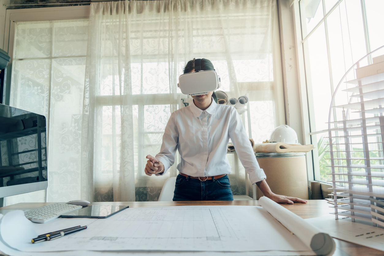 Young female working in the Metaverse with a virtual reality headset.
