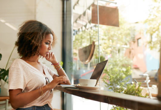 Small Business Owner reading our blog about trends affecting SMBs in 2023.